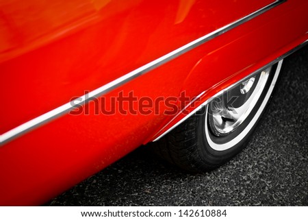 Detail of the back wheel of a vintage red car