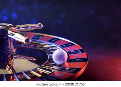 Detail of ball fixed on the black six of a casino roulette wheel on table and dark isolated background with soft red and blue lighting in the dark. - Powered by Shutterstock