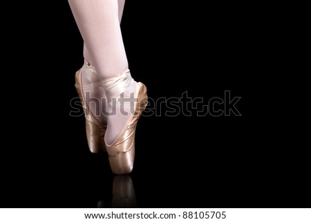 detail of ballet dancer feets on black background