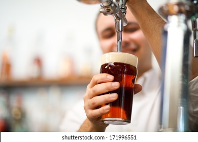 Detail Of A Bartender Brewing A Beer 