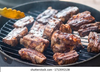 Detail Of BBQ Pork Ribs Grilling On Home Smokehouse