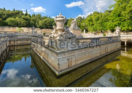 Detail of the beautiful fountain in the Jardin de la Fontaine in Nimes. Le Nymphée with sculpture group at the park Les Jardin de la Fontaine in Nimes, Gard, Provence, France