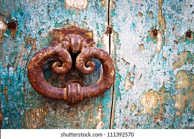 Detail of beautiful, ornate door knocker on an antique portal. - Powered by Shutterstock