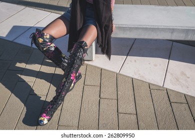 Detail Of A Beautiful Young Brunette With Over The Knee Boots Sitting On A Bench