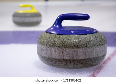 Detail of blue curling stone  on ice