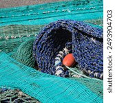 Detail of a blue fishing net drying in the harbour of Hirtshals, Denmark.