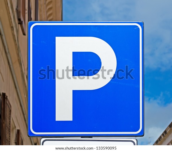 detail of a blue\
parking sign in a urban\
street