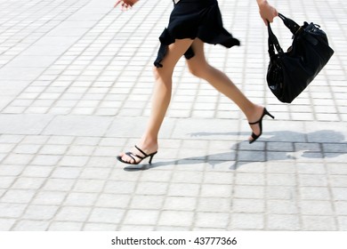 Detail In Blur Of  Woman Legs Running On The Pavment