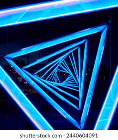 Detail of a bright triangular light blue tunnel conveys a distorted or twisted reality concept. Closeup of a light blue triangle shape passage resembles a tunnel through an unknown, alien reality