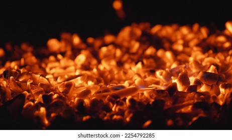 Detail of burning coals, sparks, blowing, maintaining fire fire - Shutterstock ID 2254792285