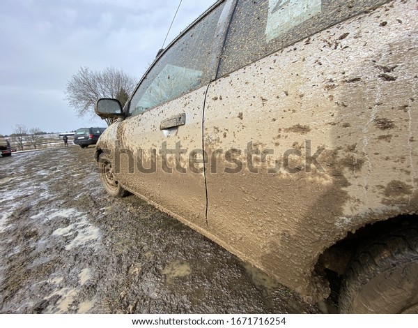 The detail of the car completely dirty by mud
after the drag race on a field during winter. It needs complete
cleaning of the exterior and interior.
