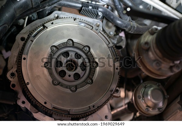 Detail of Car flywheel assembly in a workshop, car\
reparation engine
