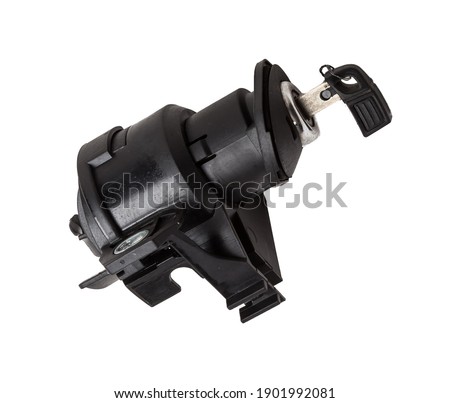 Detail of a car spare part made of black plastic and metal - keyhole lock with key for opening the trunk separately, isolated on a white background. Repair in a car workshop, equipment for sale.