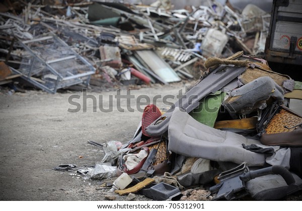 Detail\
of car waste, metal and plastic parts on the\
stack