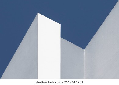 detail of cement walls painted white and gray against a blue sky in a composition with a strong geometric feel. straight lines like a stairs. Abstract design in architecture for background - Powered by Shutterstock