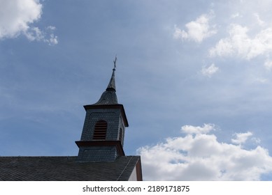 Detail Of A Church Spire Against A Cloudy Sky