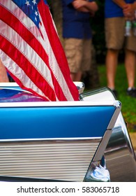 Detail Of A Classic Car With An American Flag Attached Driving In A Fourth Of July Parade. 