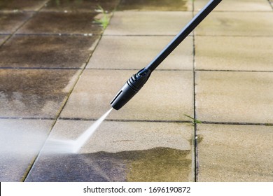 Detail of cleaning terrace with high-pressure water blaster