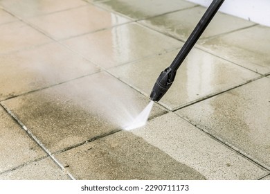 Detail of cleaning terrace with high-pressure water blaster, cleaning dirty paving stones - Shutterstock ID 2290711173