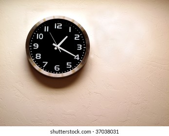 Detail Of Clock Face With Numbers And Hands Showing Time