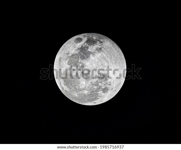 Detail close up of full moon, is the lunar\
phase when the Moon appears fully illuminated from Earth\'s\
perspective. This occurs when Earth is located between the Sun and\
Moon, lunar hemisphere.