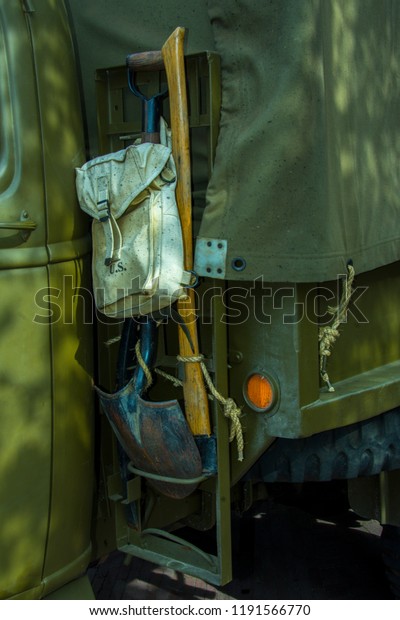 A detail, close up, of an army\
vehicle in the green protective color. The army puts vehicles like\
this in a war situation. Suitable for a background or\
back-drop.