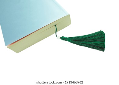 A Detail Of A Closed Book With A Bookmark, Isolated On Pink Background.