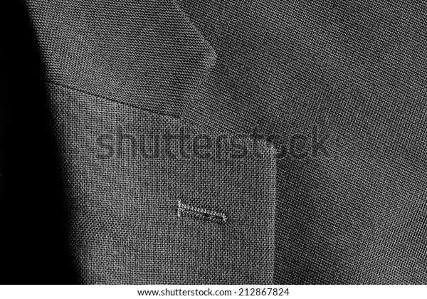 Detail closeup close-up of suit jacket lapel\
button hole fabric