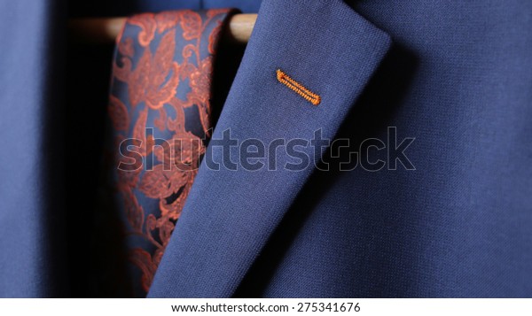 Detail closeup close-up of suit jacket lapel\
button hole fabric