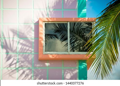 Detail close-up of typical colorful Art Deco architecture with tropical palm tree shadows in South Beach, Miami, Florida