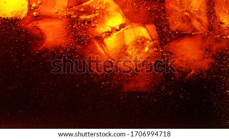 Detail of cola drink with ice cubes, fresh beverages background.
