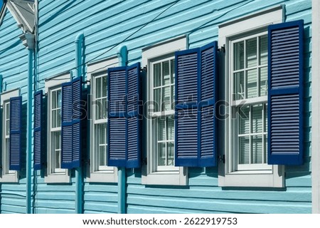 Detail of a colorful blue house with wooden shutters, vibrant colors architecture in Key West, Florida