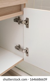 detail of concealed hinge on cabinet door, furniture fitting hardware for cupboard or wardrobe, kitchen or bathroom cabinet accessory