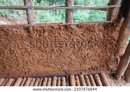 Detail of construction of a good house with walls made of mud, straw and bamboo.