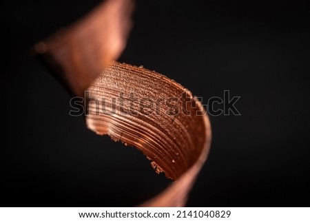 Detail of copper, a scrap material swirl close-up with textured surface. Expensive resource metal ready to be recylced and used in the industry. Circular economy concept