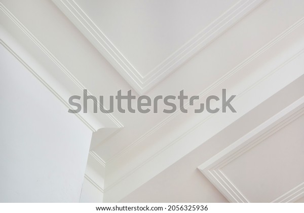 Detail of corner ceiling cornice with intricate crown\
molding. 