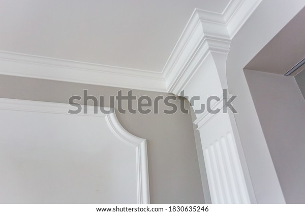 Detail\
of corner ceiling with intricate crown molding.\
