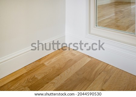Detail of corner flooring with intricate crown molding and plinth. 