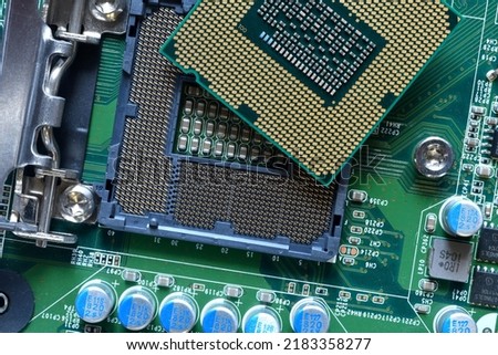 Detail of a CPU Processor over his Socket on a Motherboard. Printed Circuit Board - Computer Motherboard with Components. Close-up