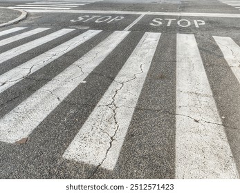 Detail of a crossing with pedestrian crossings and a stop sign for cars. - Powered by Shutterstock