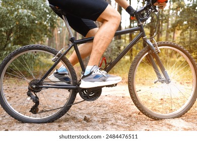 Detail of cyclist man feet riding mountain bike on outdoor trail in sunny forest. - Powered by Shutterstock