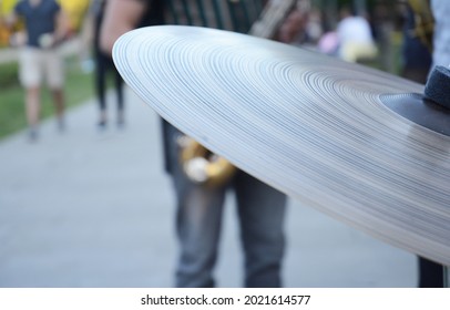 a detail of a cymbal in a street concert
