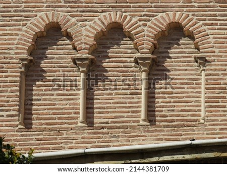 Detail of decoration in the bell tower with trefoil arches. Islamic mudejar decoration. 12 century. Church of San Nicolas. Historic city centre of Madrid. Spain.