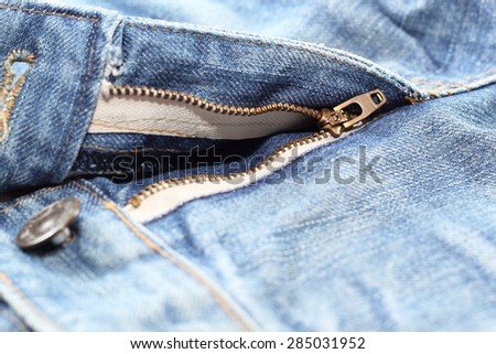 Detail of denim zipper on old worn jeans