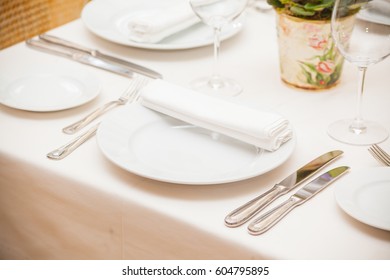 Detail Of A Dining Table Set Up With Wine Glasses.