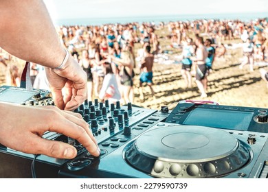 Detail of dj playing modern sound on cd usb player at spring break festival - Beach music party and life style concept - Defocused background with shallow depth of field - Bright vivid filter - Powered by Shutterstock