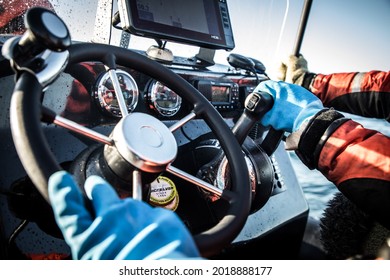 Detail of drivers hands with a speed boat dashboard
