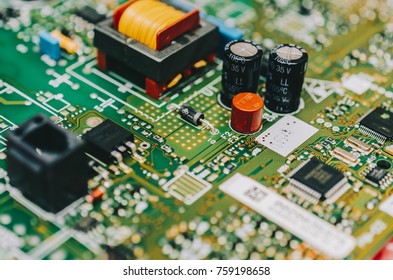 Detail of an electronic printed circuit board with many electrical components - Powered by Shutterstock