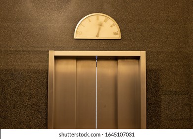 Detail of an elevator door with moving pointer on a vintage floor level display