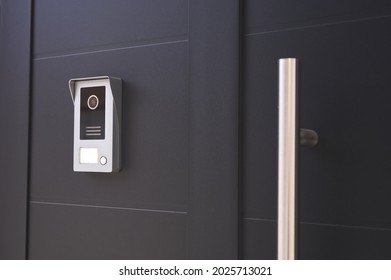 detail of an entrance door to a house with a doorbell with camera - Shutterstock ID 2025713021